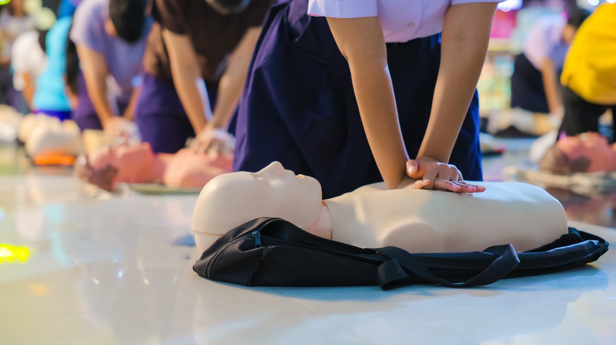 Person performing CPR chest compressions during a training session